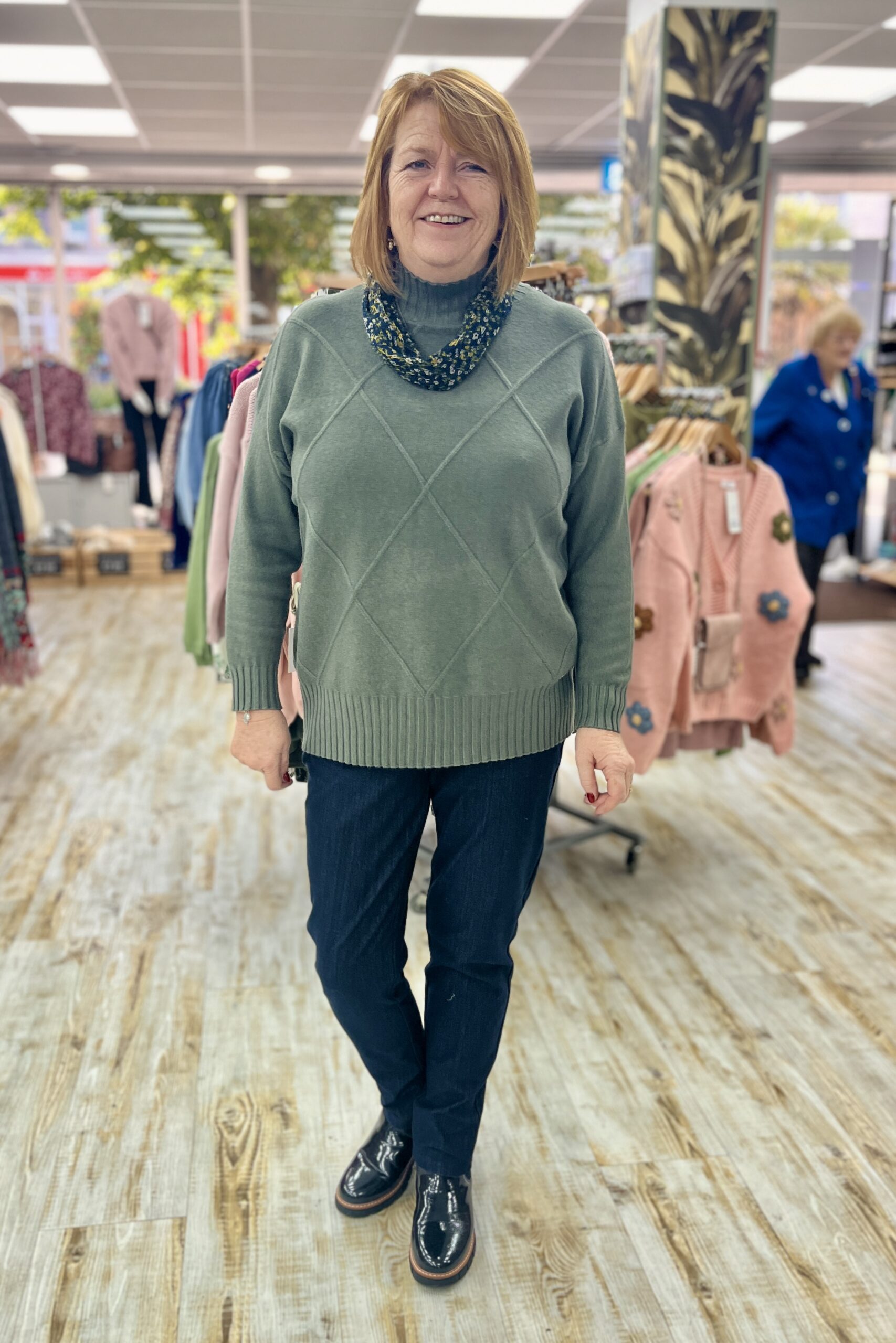 Clathers Store, Minehead, Dawn Wearing a Khaki Jumper and Jeggings with Black Chelsea Boots and a Magnetic Scarf.
